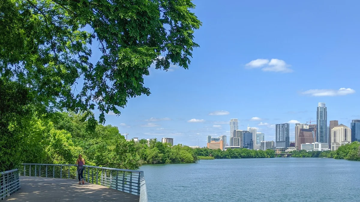 The Lady Bird Lake hike-and-bike trail with the Austin skyline behind