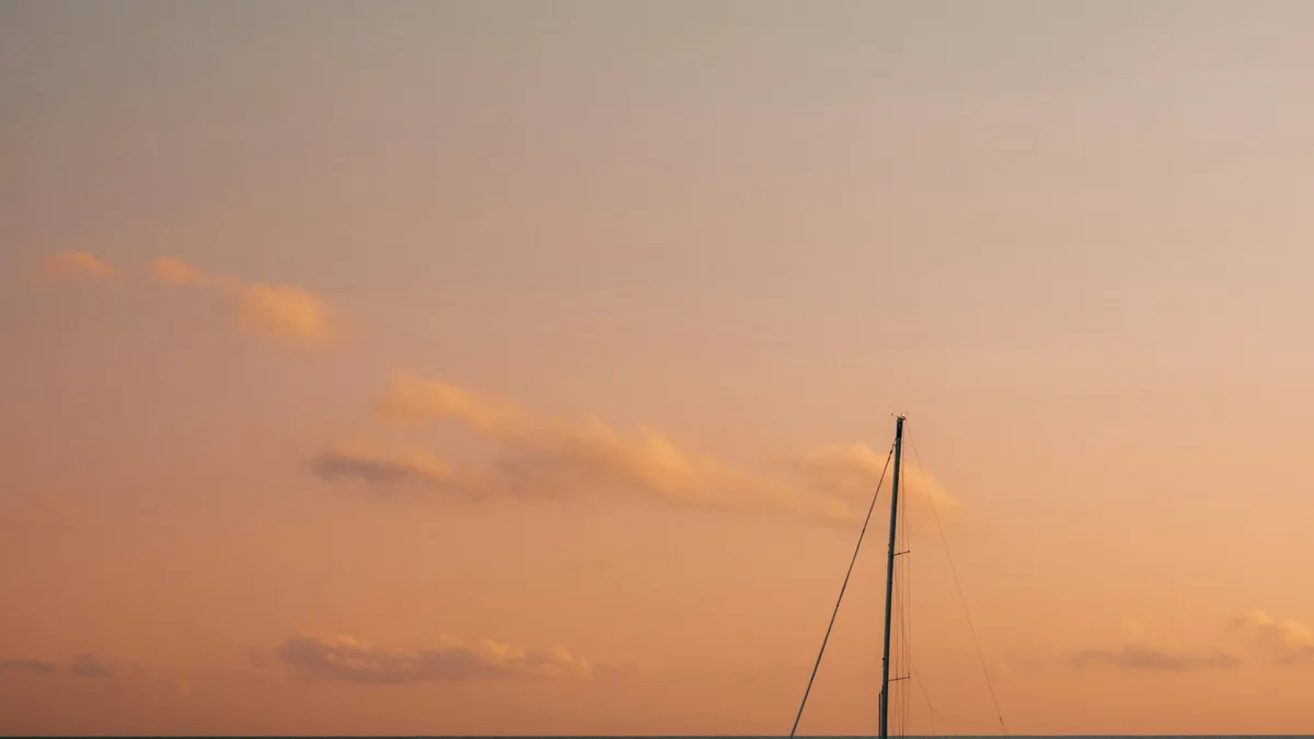 A yacht at sunset on open water