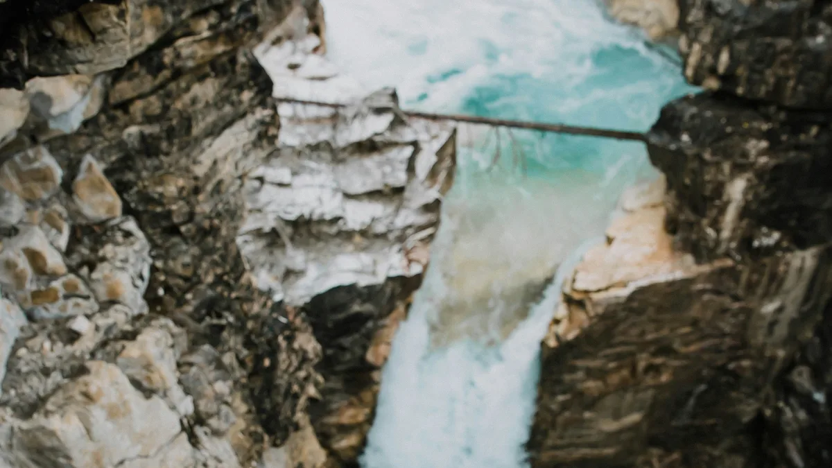 A waterfall cascading through the narrow marble walls of Marble Canyon, Banff, Alberta