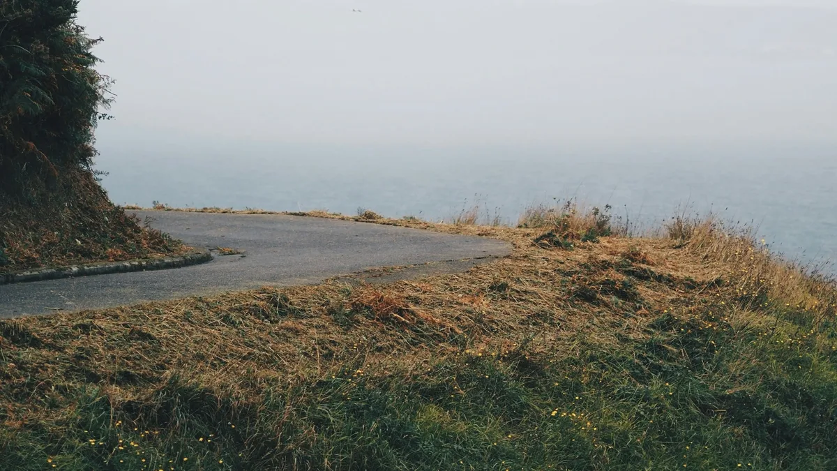 A quiet coastal road along the rugged Maine shoreline