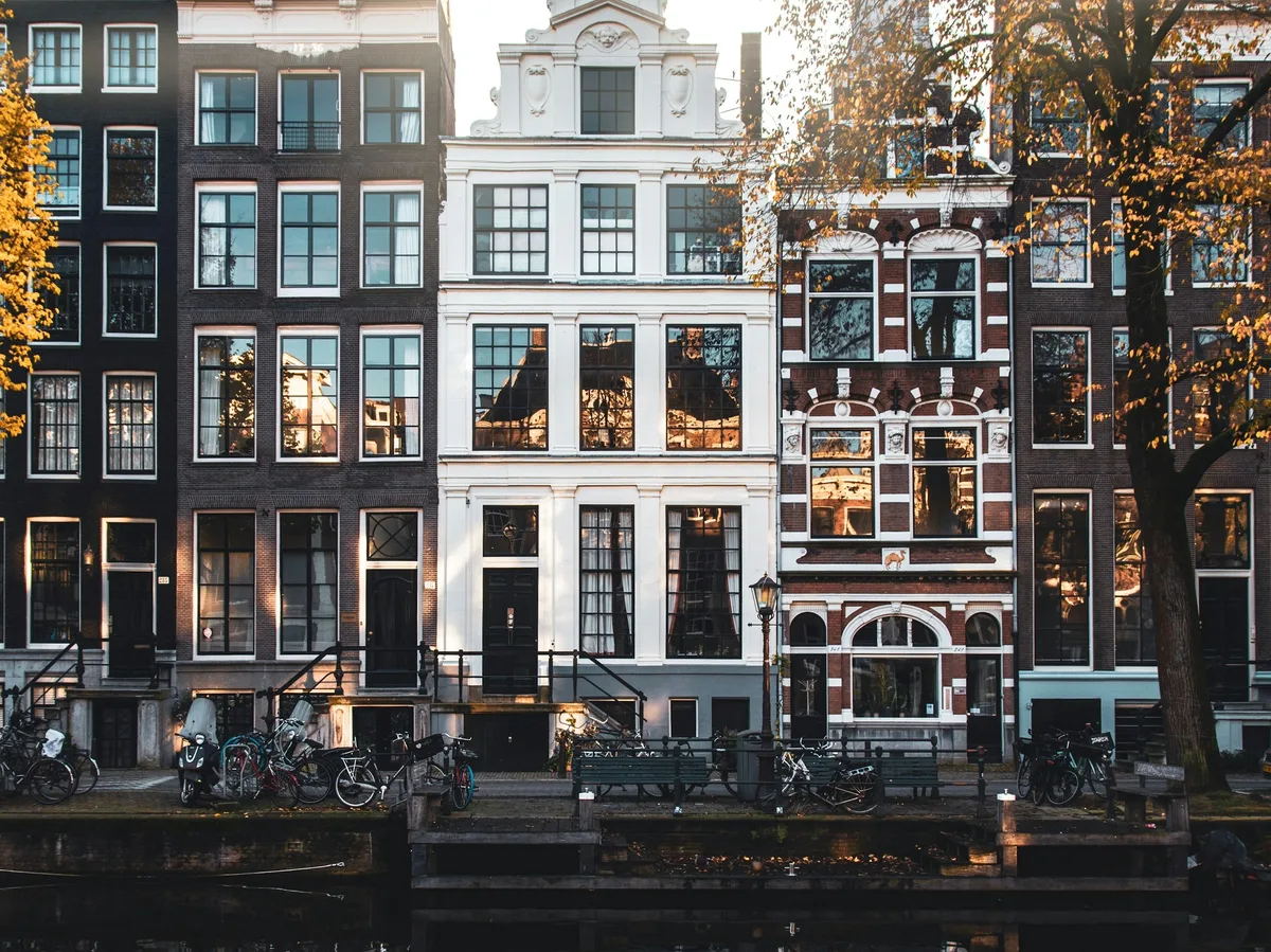 Canal houses and a canal boat in Amsterdam at golden hour