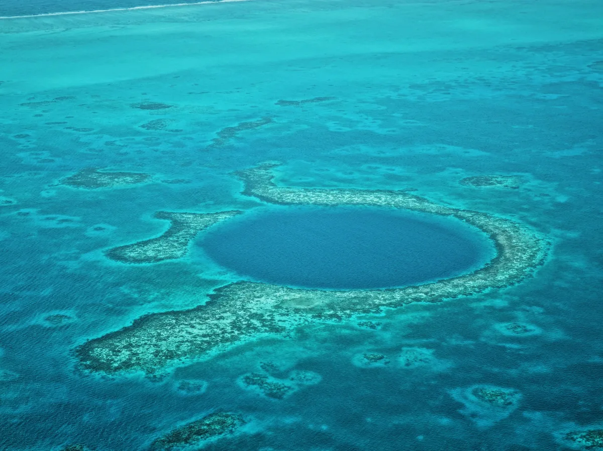 Aerial view of the Great Blue Hole, a circular marine sinkhole off the coast of Belize