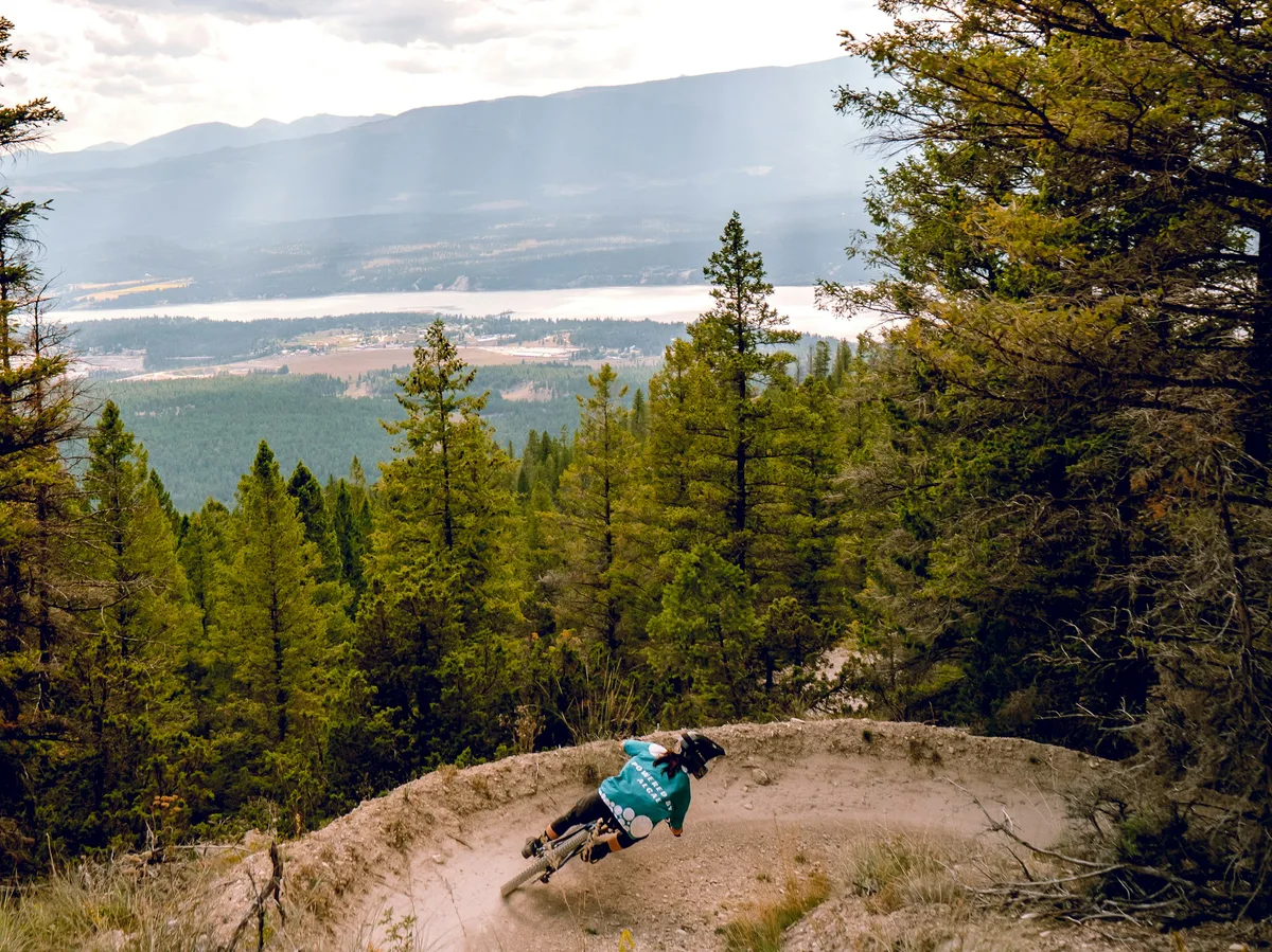 A cyclist riding a mountain bike along a scenic mountain trail