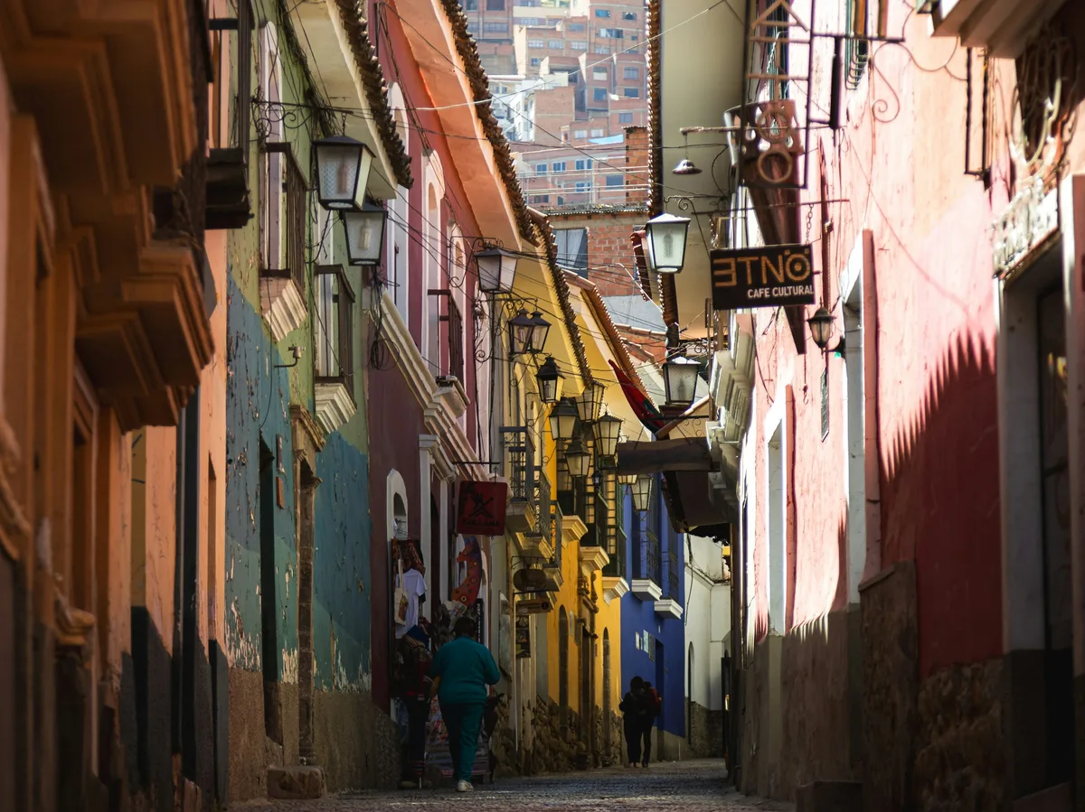 A narrow street in La Paz, Bolivia, backed by the Andean skyline