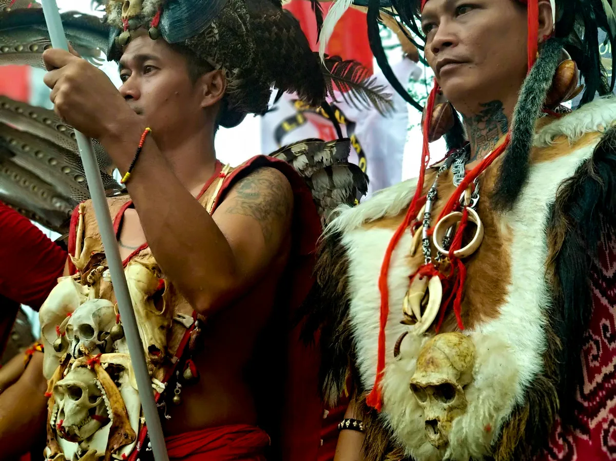 Two men in traditional Sarawak tribal dress at a cultural event in Kuching, Malaysia