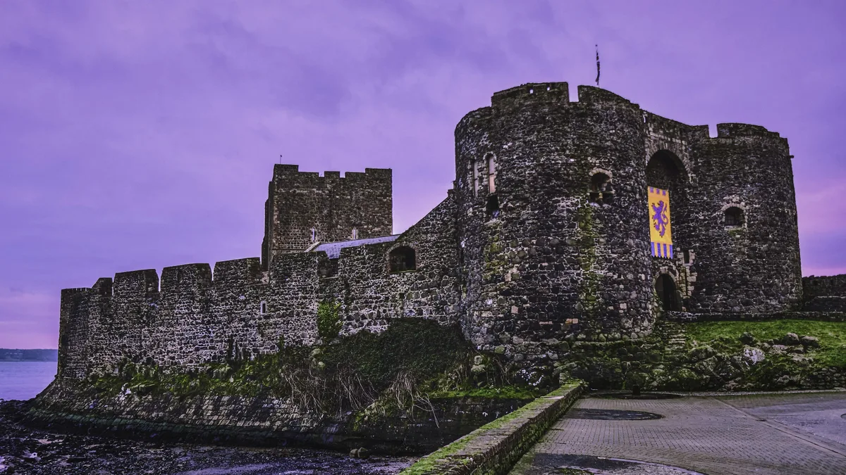 A stone medieval-style castle on a rocky coastline