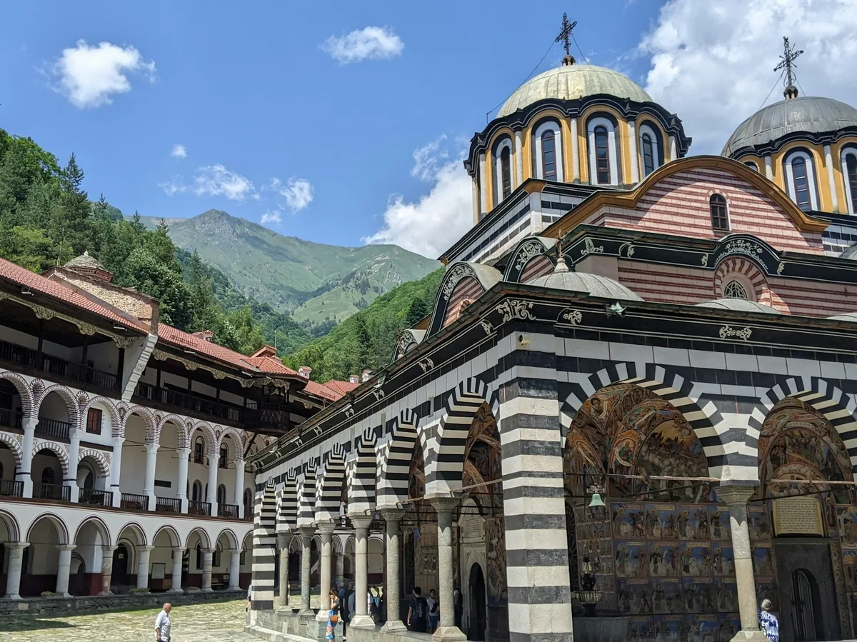 The courtyard of Rila Monastery, Bulgaria, with its striped arcades and frescoed walls