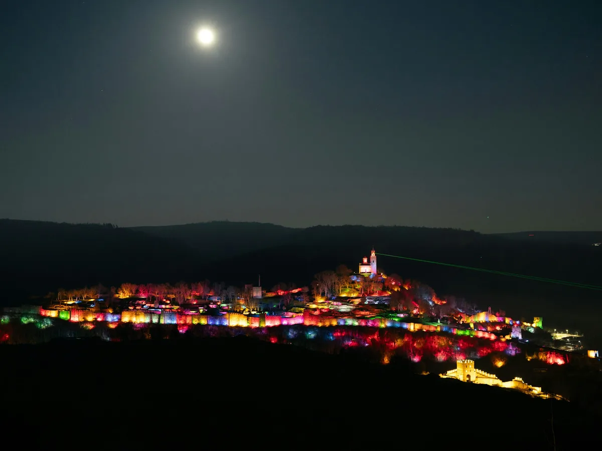 Tsarevets Fortress illuminated at night above Veliko Tarnovo, Bulgaria's former medieval capital