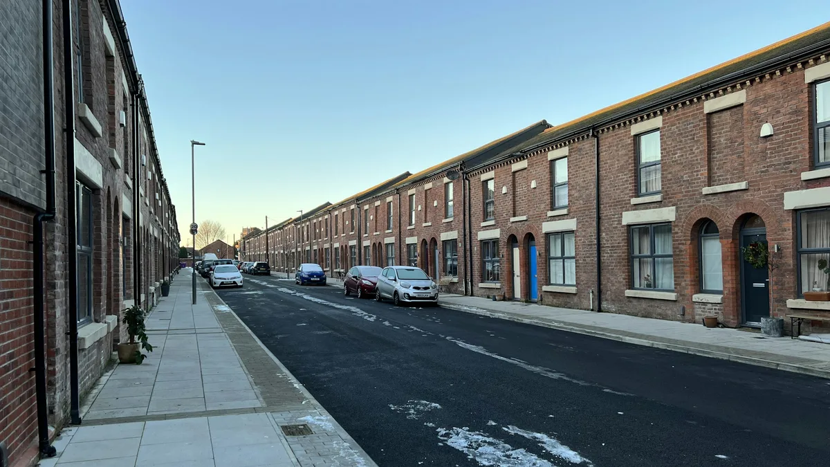 Rows of historic brick row houses on a quiet residential street
