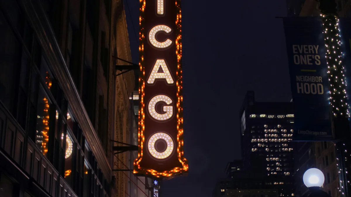 A classic movie theater marquee on a downtown street
