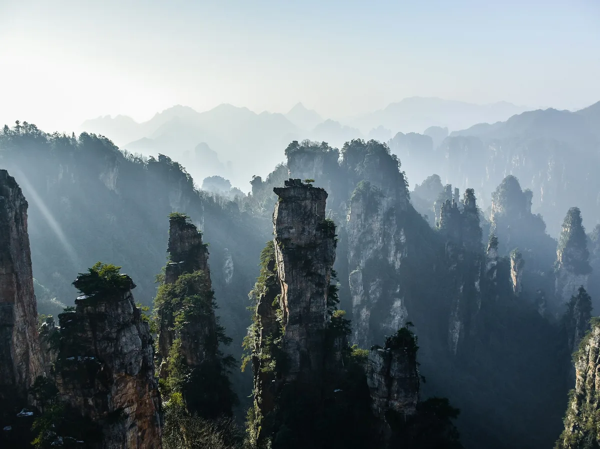 Sandstone pillar peaks rising through mist in Zhangjiajie National Forest Park