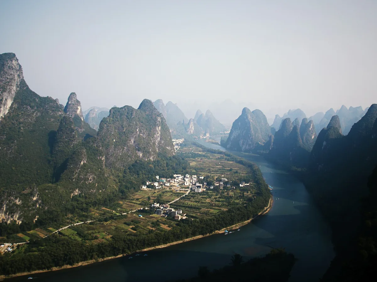 A karst mountain rising beside the water near Yangshuo, China
