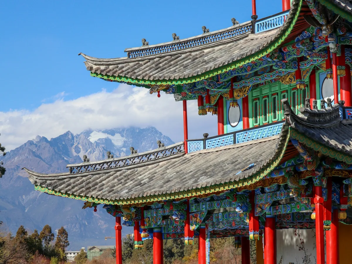 Traditional red-pillared building beside a lake in Lijiang Old Town