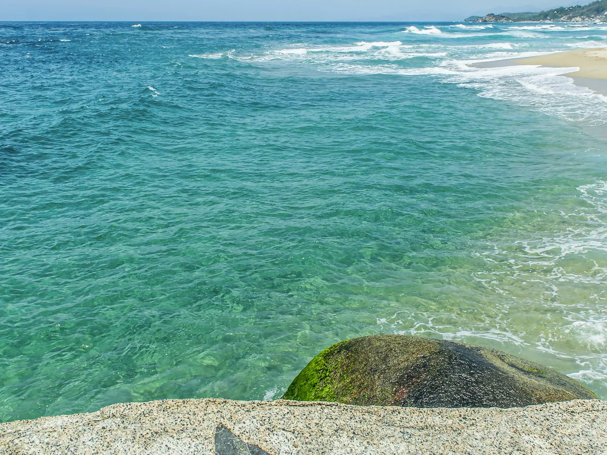 Dramatic coastal cliffs where the ocean meets the shore along Colombia's Caribbean coast