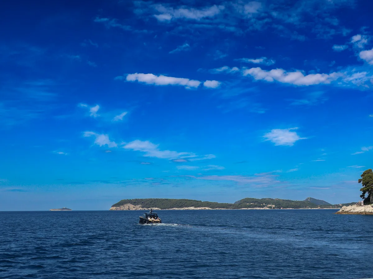 A small wooden boat anchored off one of the Elaphite Islands near Dubrovnik, Croatia