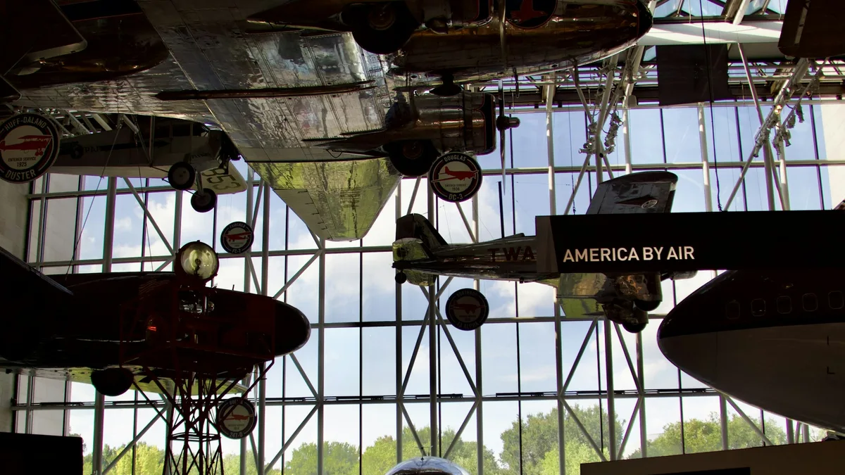 A vintage aircraft suspended inside a museum gallery