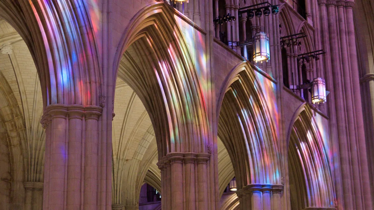 A grand Gothic cathedral interior with soaring stone arches