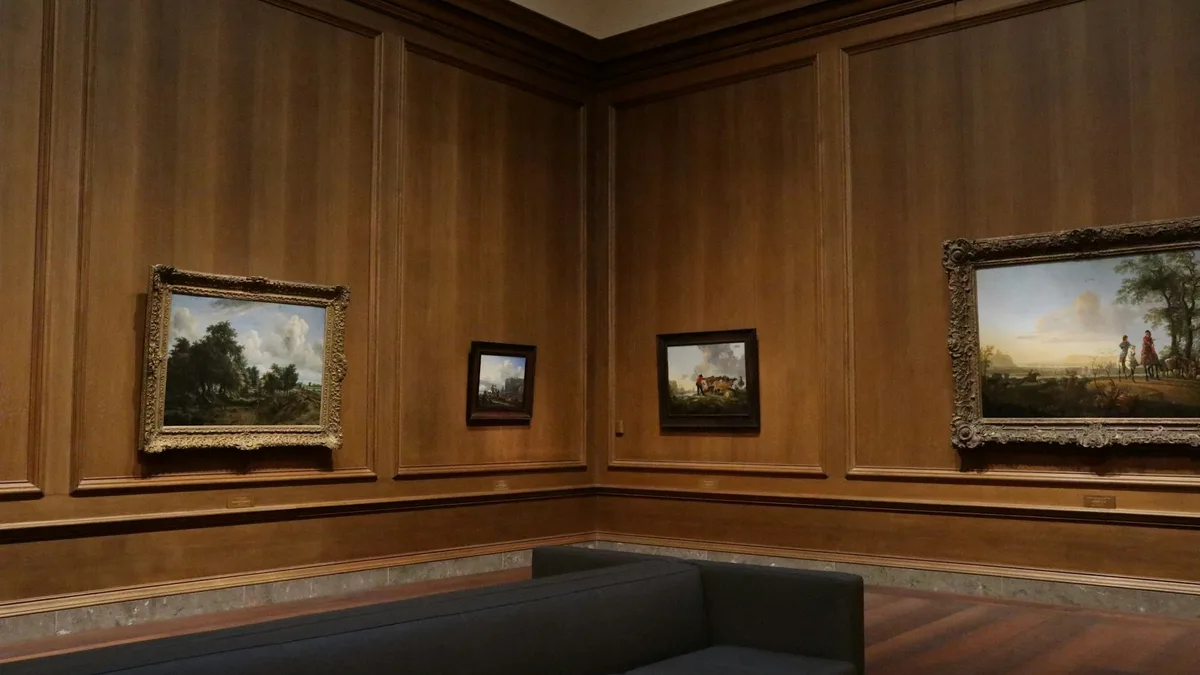 Classical paintings displayed on the wall of an art gallery
