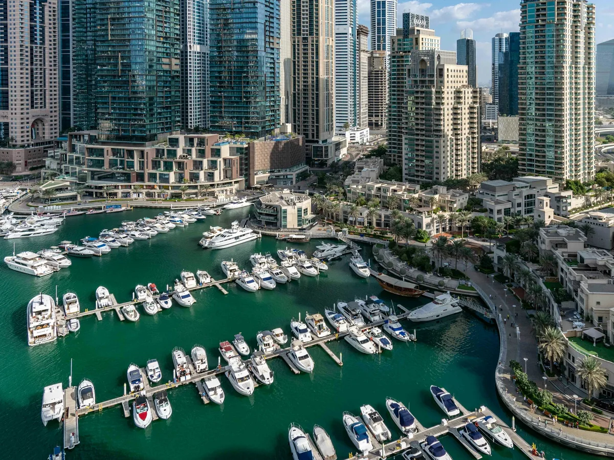 Yachts docked in Dubai Marina surrounded by skyscrapers