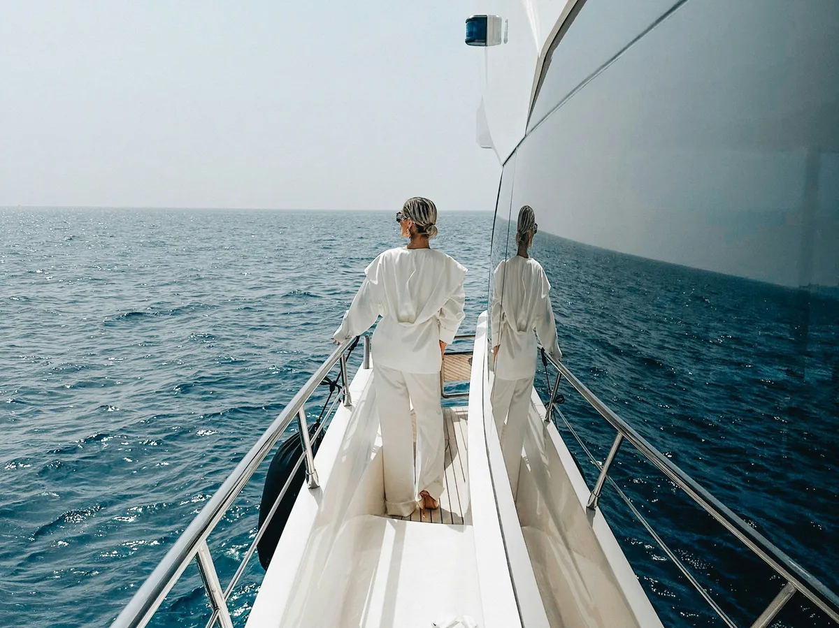 Two people standing on the deck of a yacht in Dubai