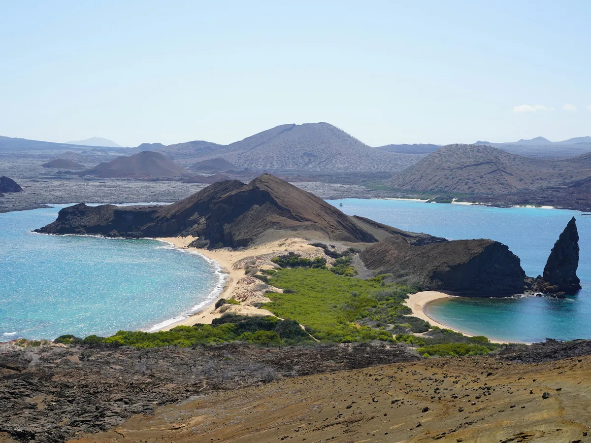 A sandy Galapagos island beach with turquoise water