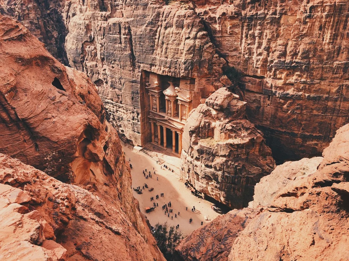 Petra's Treasury facade carved into the pink sandstone canyon wall, Jordan