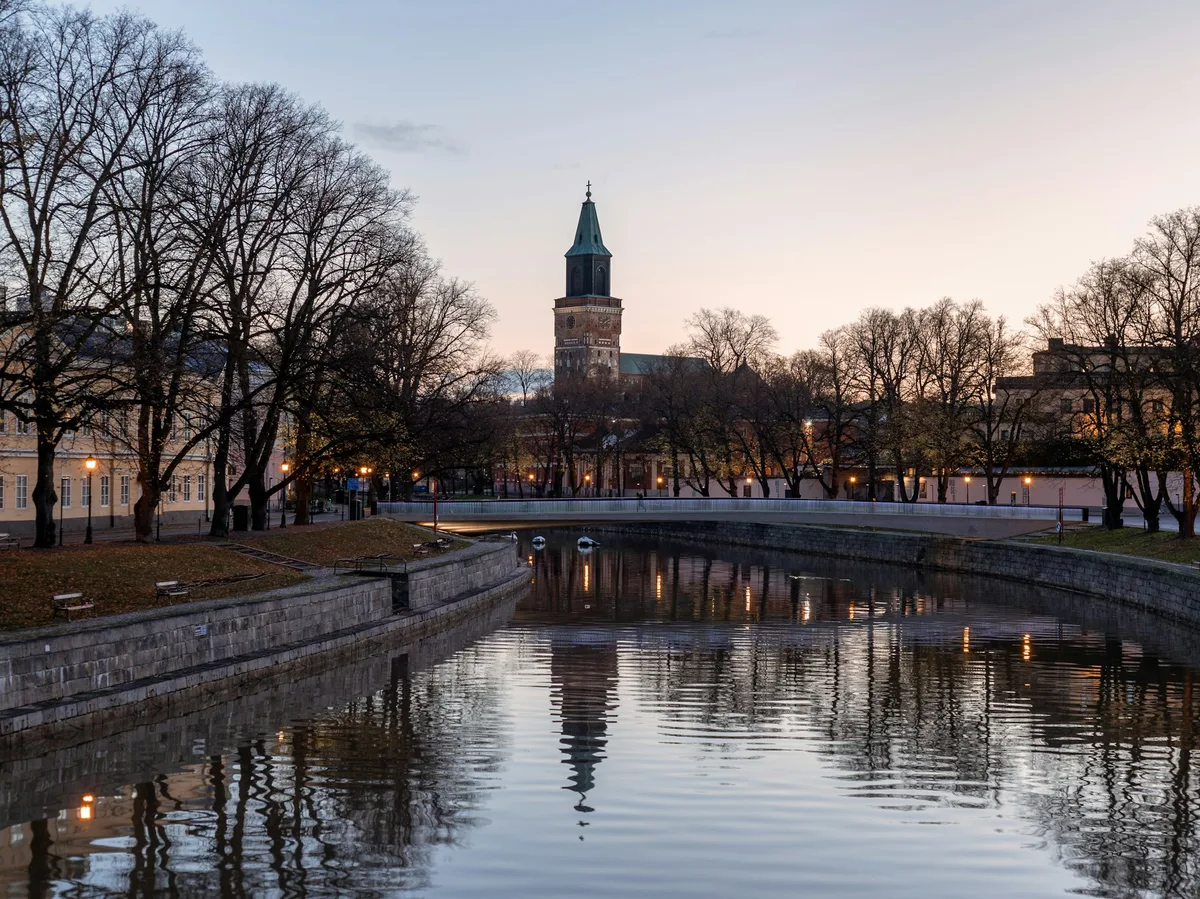 The Aura River running through Turku, Finland, with the medieval cathedral in the background