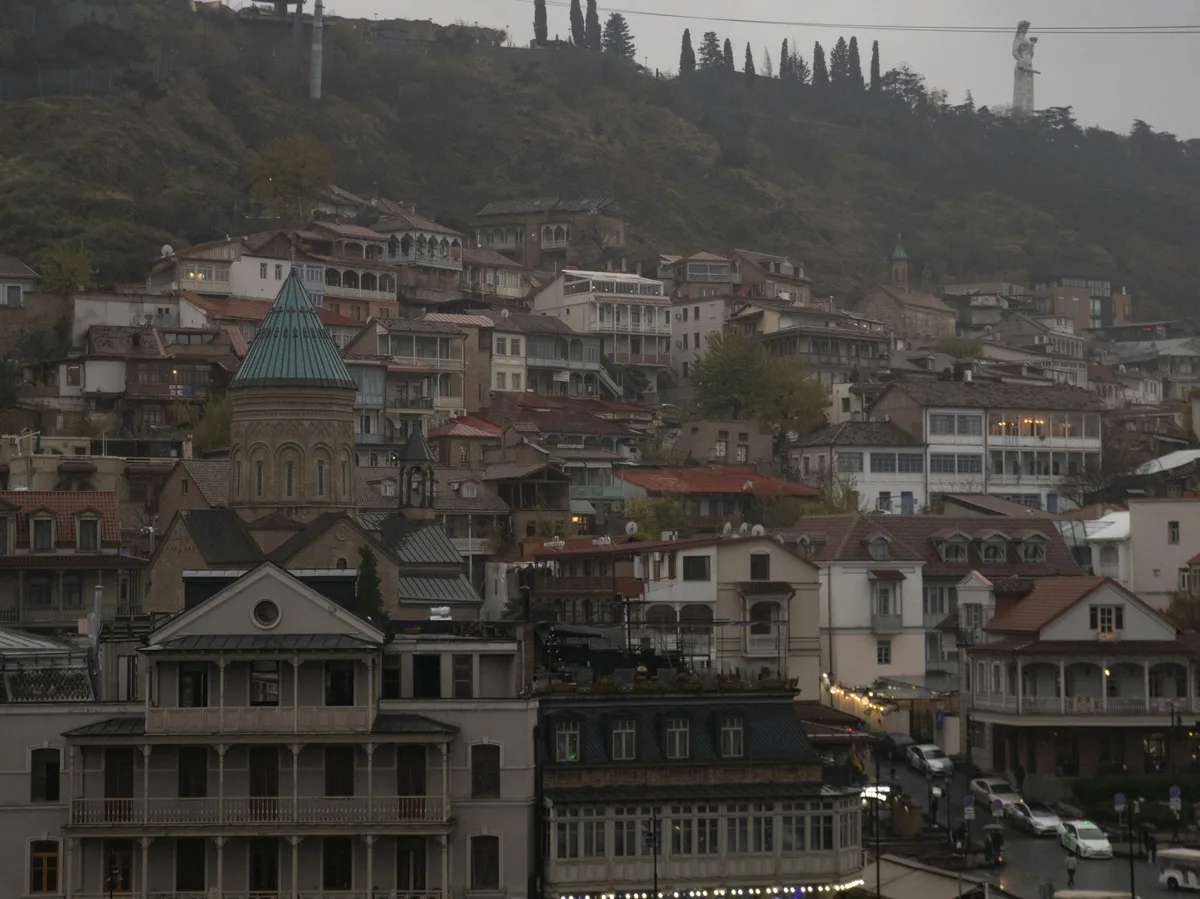 Colorful balconied houses along a narrow street in Tbilisi's Old Town, Georgia