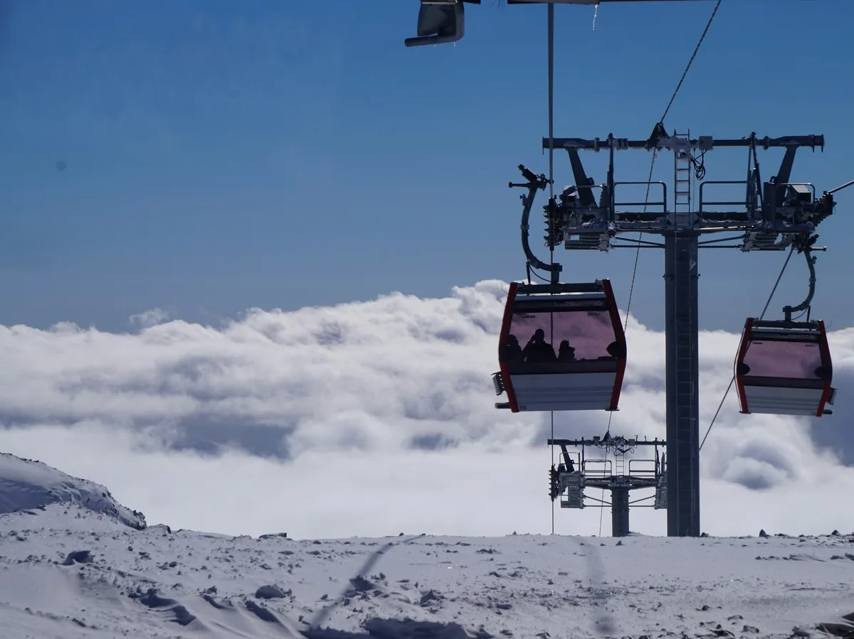 Ski lift rising above the clouds at a Caucasus mountain resort
