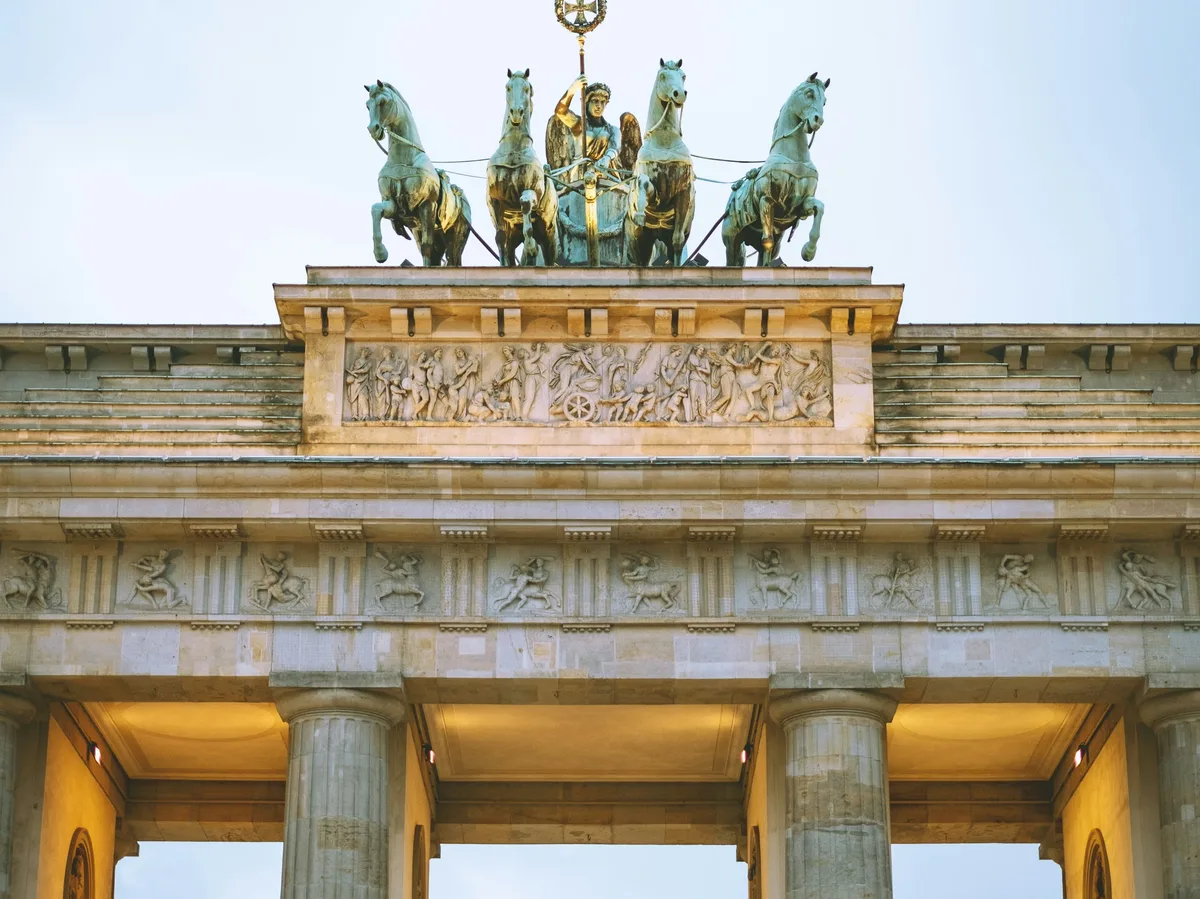 The Brandenburg Gate in Berlin, Germany, lit up at dusk