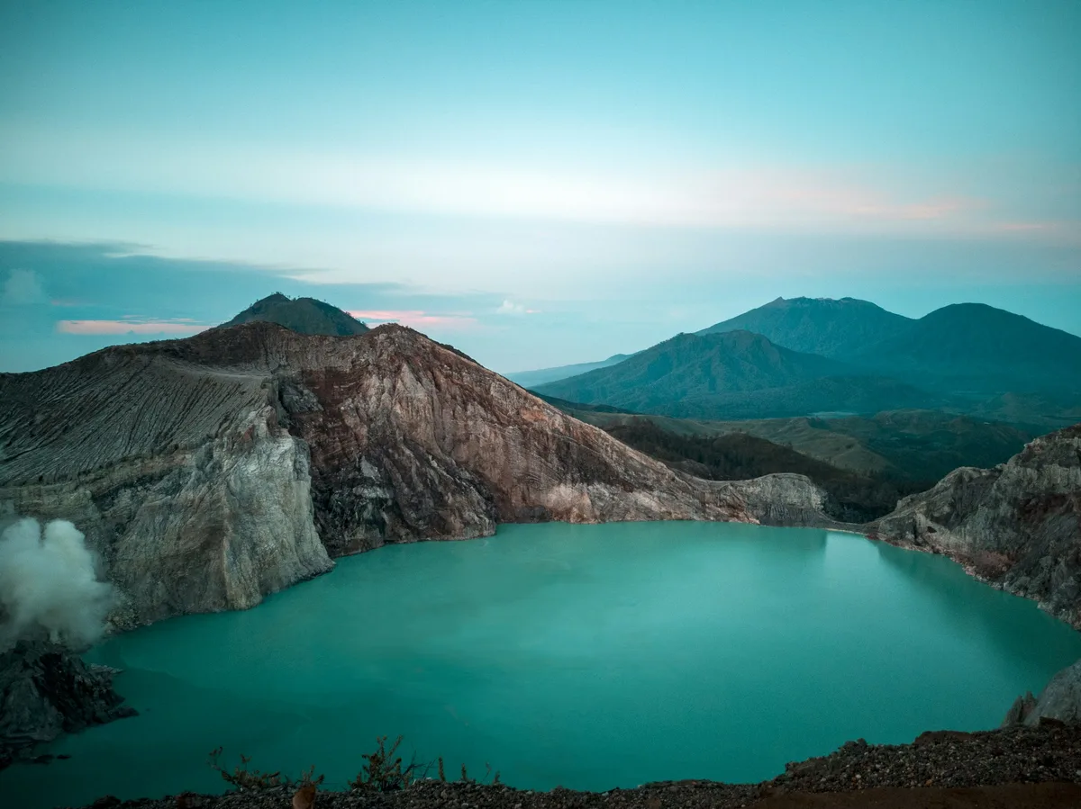 The turquoise sulfuric crater lake at the summit of Mount Ijen in East Java