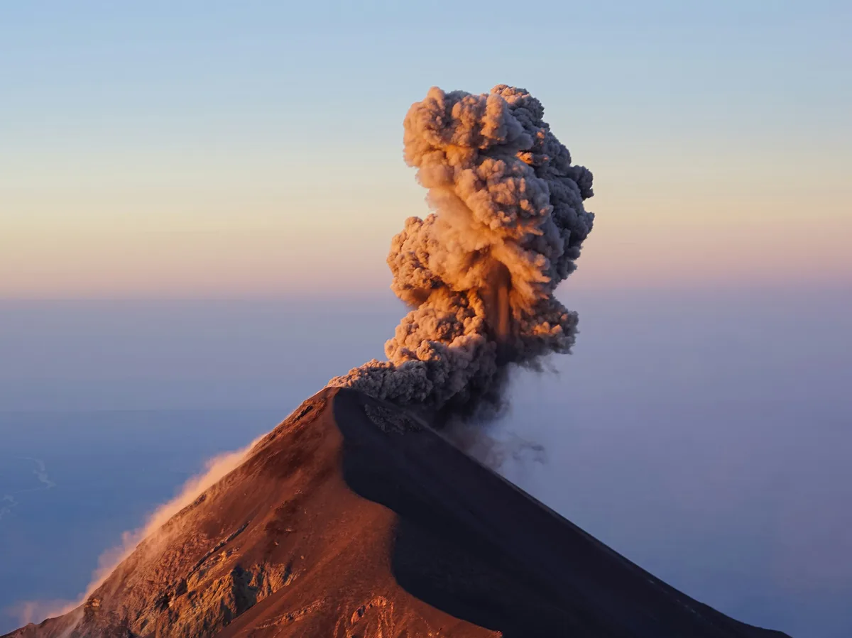 Fuego volcano erupting at night, seen from a camp on the slopes of Acatenango, Guatemala