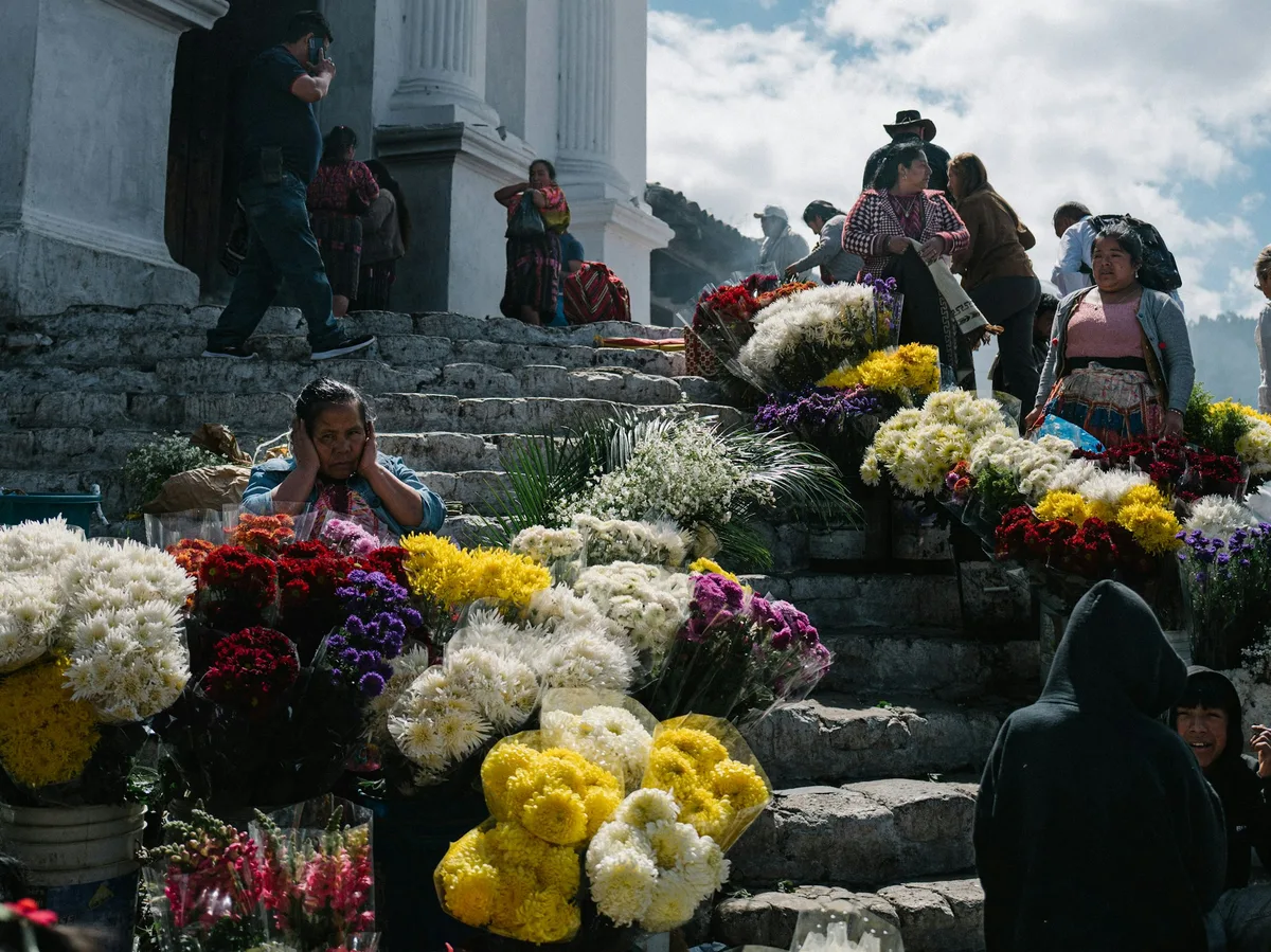 Flower sellers on the stone church steps of Chichicastenango market, Guatemala