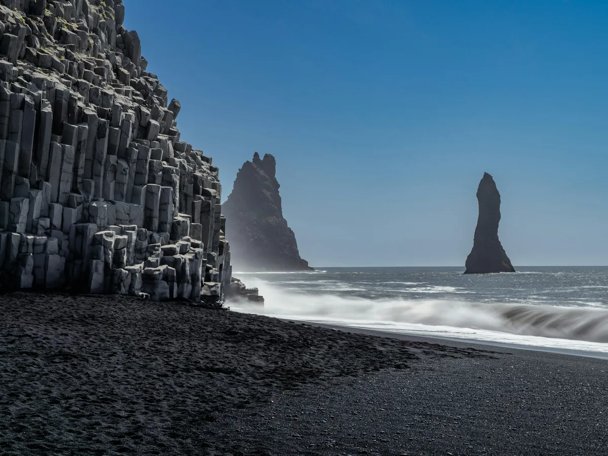 Black volcanic sand and sea stacks at Reynisfjara beach on Iceland's South Coast