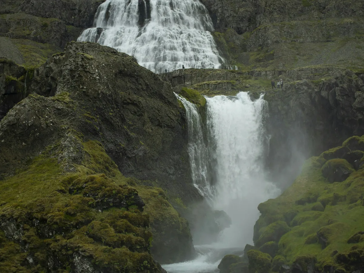 Dynjandi waterfall cascading over wide tiered rock terraces in the Westfjords of Iceland
