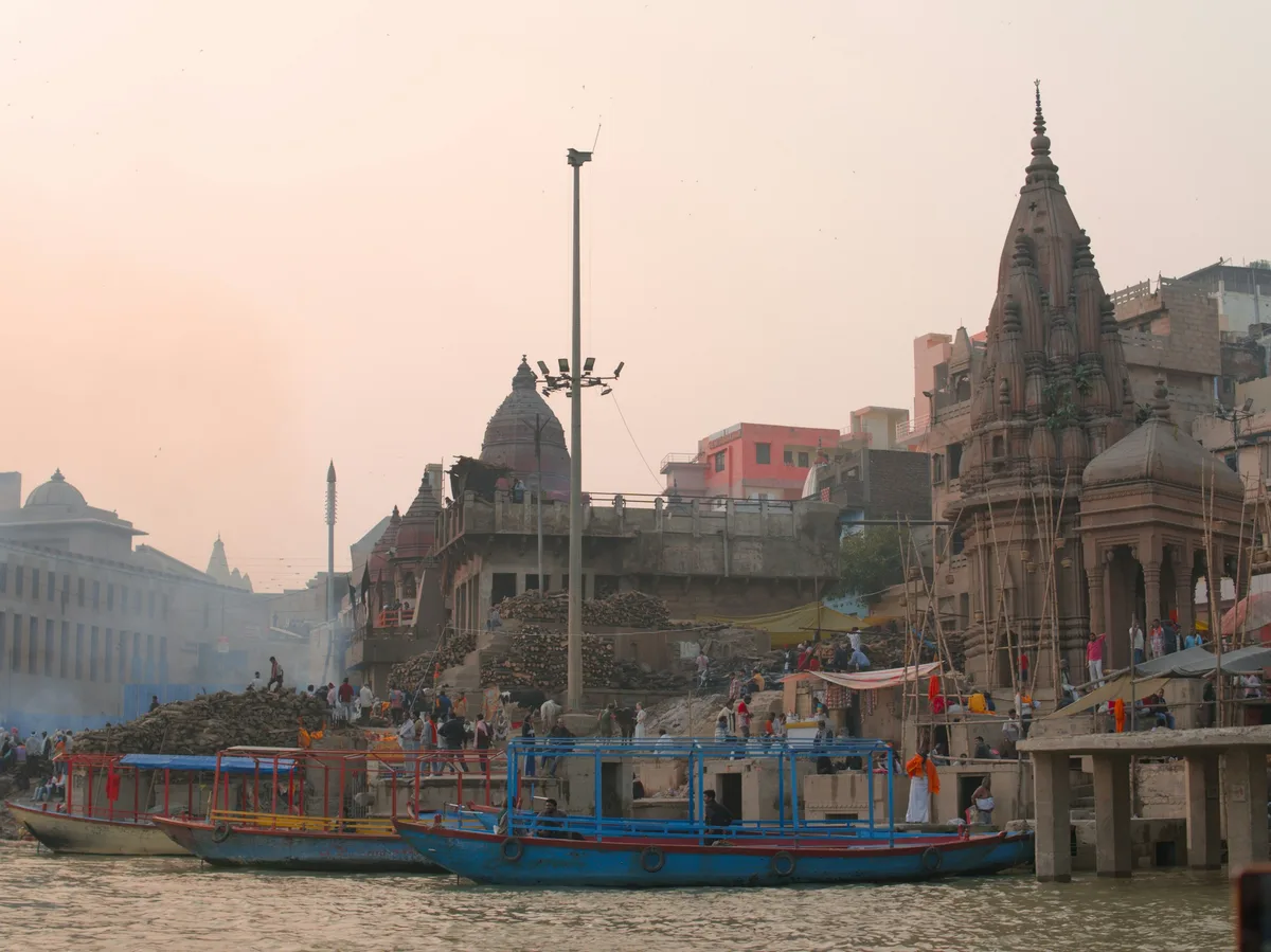 Boats on the Ganges River beneath ancient temples in Varanasi