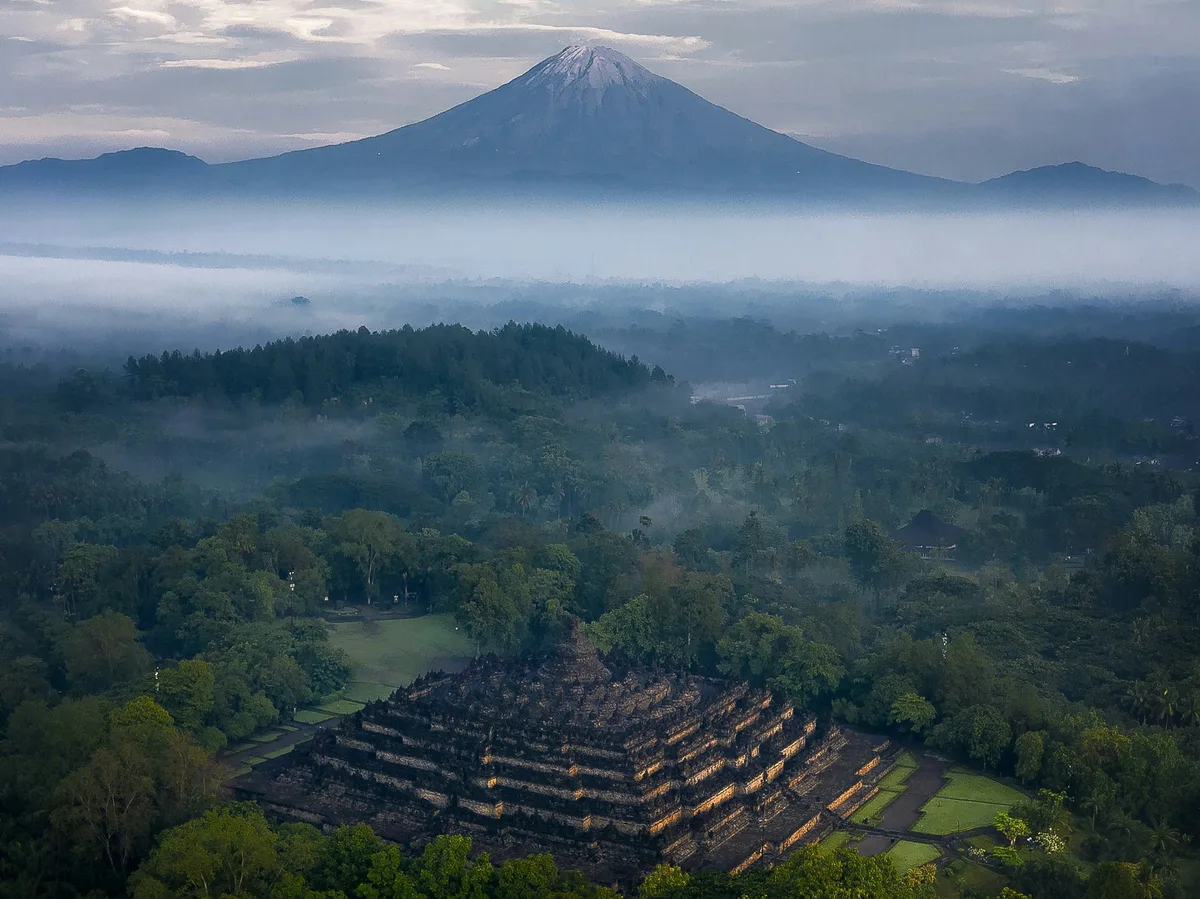 Borobudur, the world's largest Buddhist temple, rising above the Java jungle