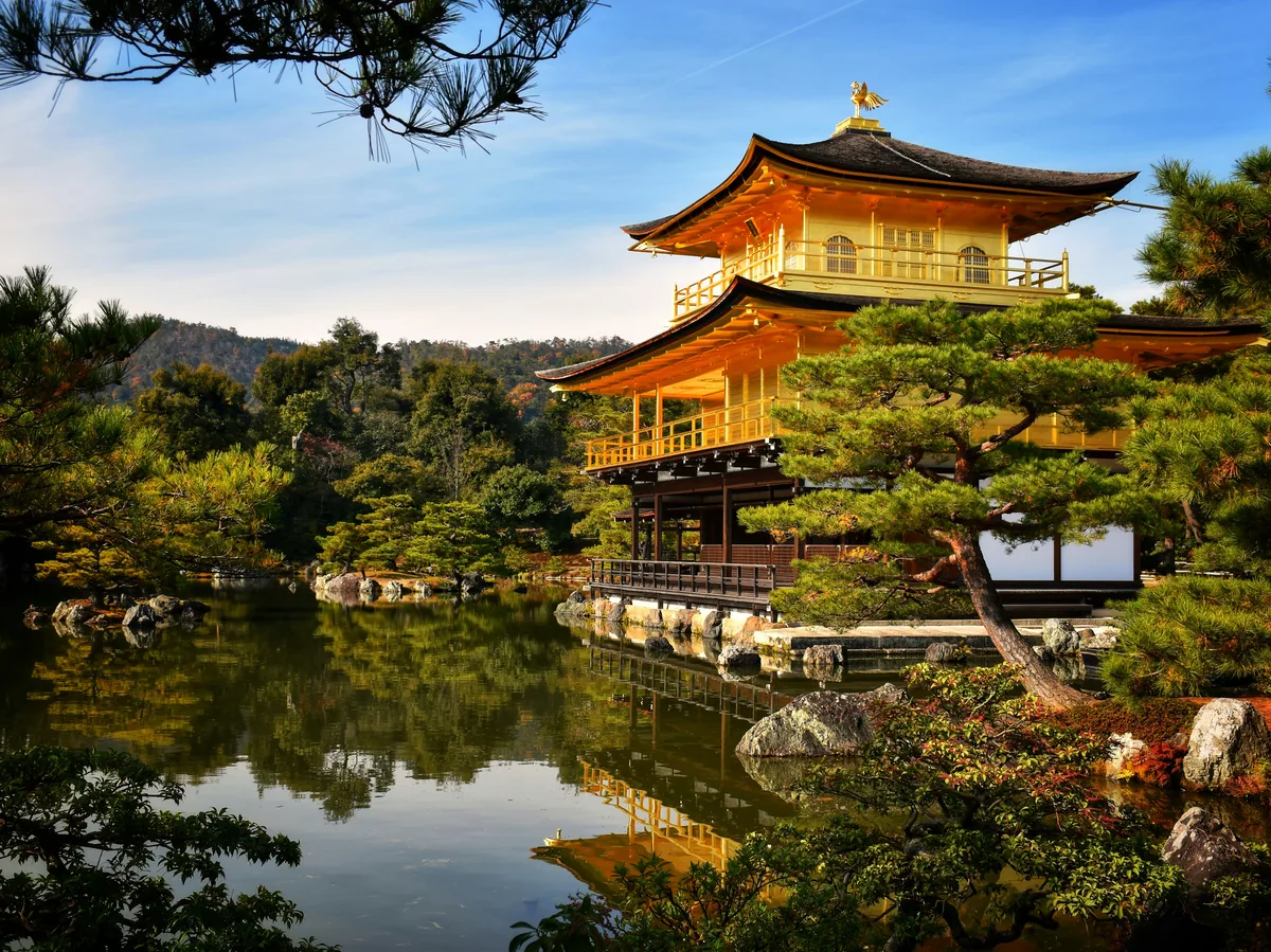 The gold-leafed Kinkaku-ji Golden Pavilion reflected in its pond in Kyoto, Japan