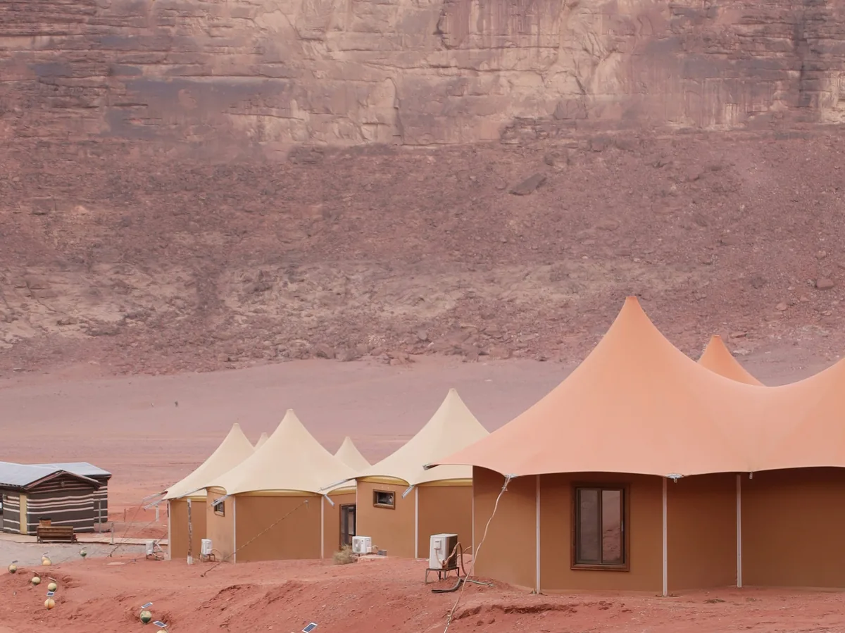 Bedouin-style tents set up in the rocky, orange desert of Wadi Rum, Jordan