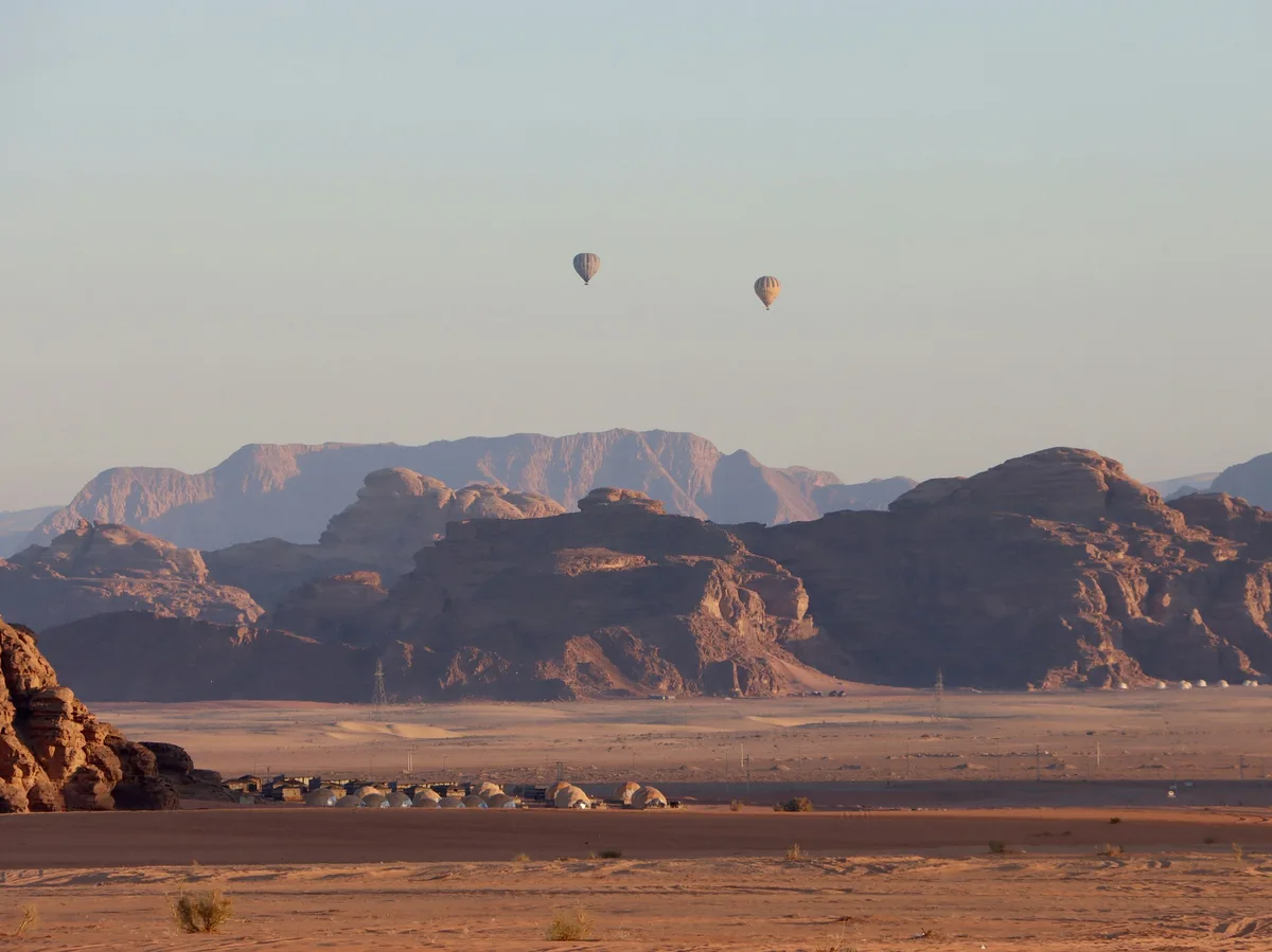 Hot air balloons drifting above the desert at Wadi Rum Village, Jordan
