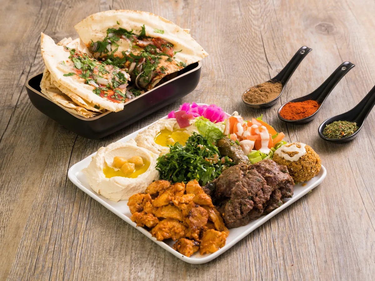 A mezze spread of hummus, falafel, and grilled meats, a taste of Jordanian cuisine