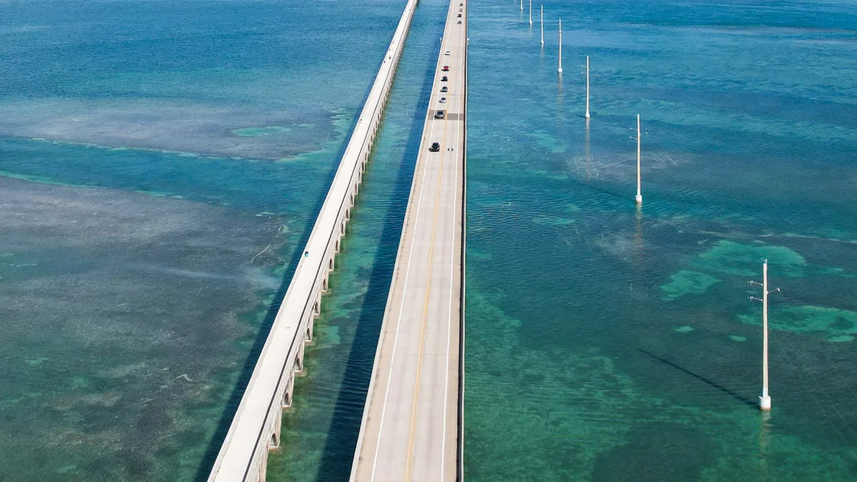 A long low bridge stretching across turquoise water