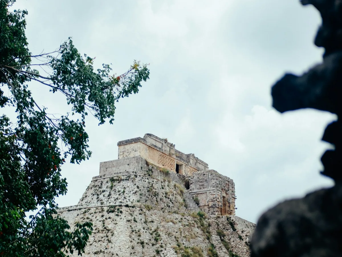 The ancient Pyramid of the Magician rising above the jungle at Uxmal, Mexico