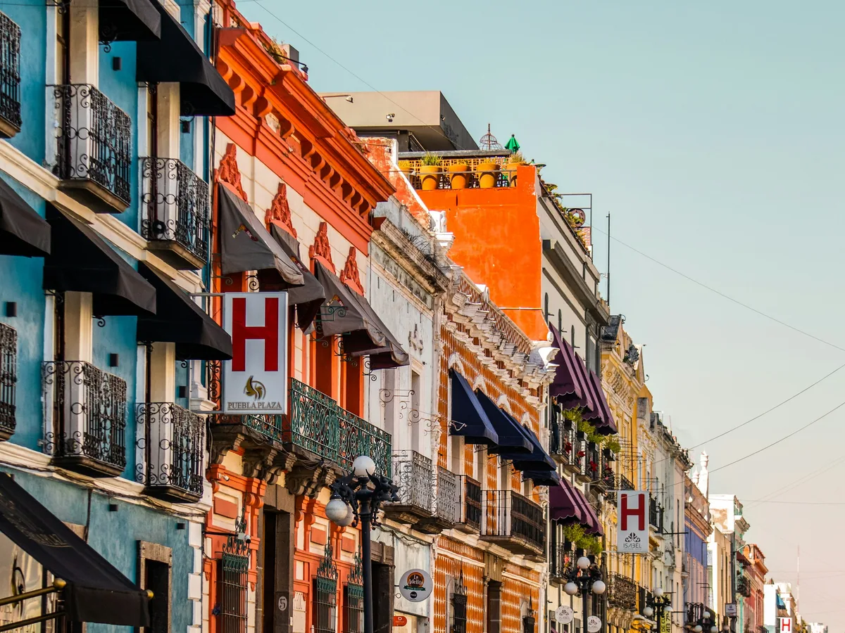 A colorful colonial street lined with balconies in Puebla, Mexico