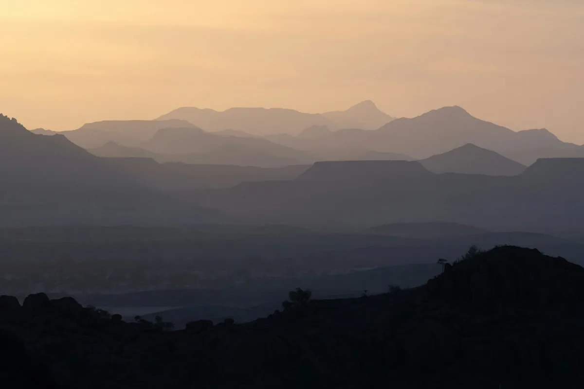 A sunset silhouette of the mountains of Damaraland, Namibia