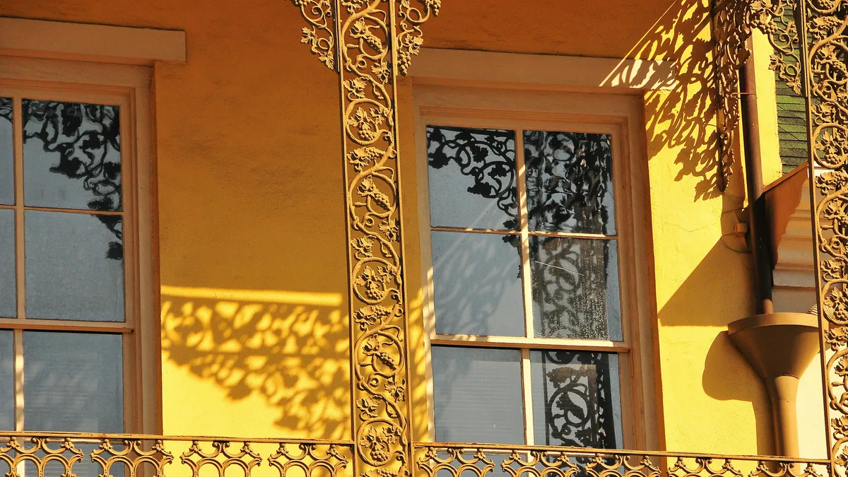 An ornate wrought-iron balcony on a historic French Quarter building