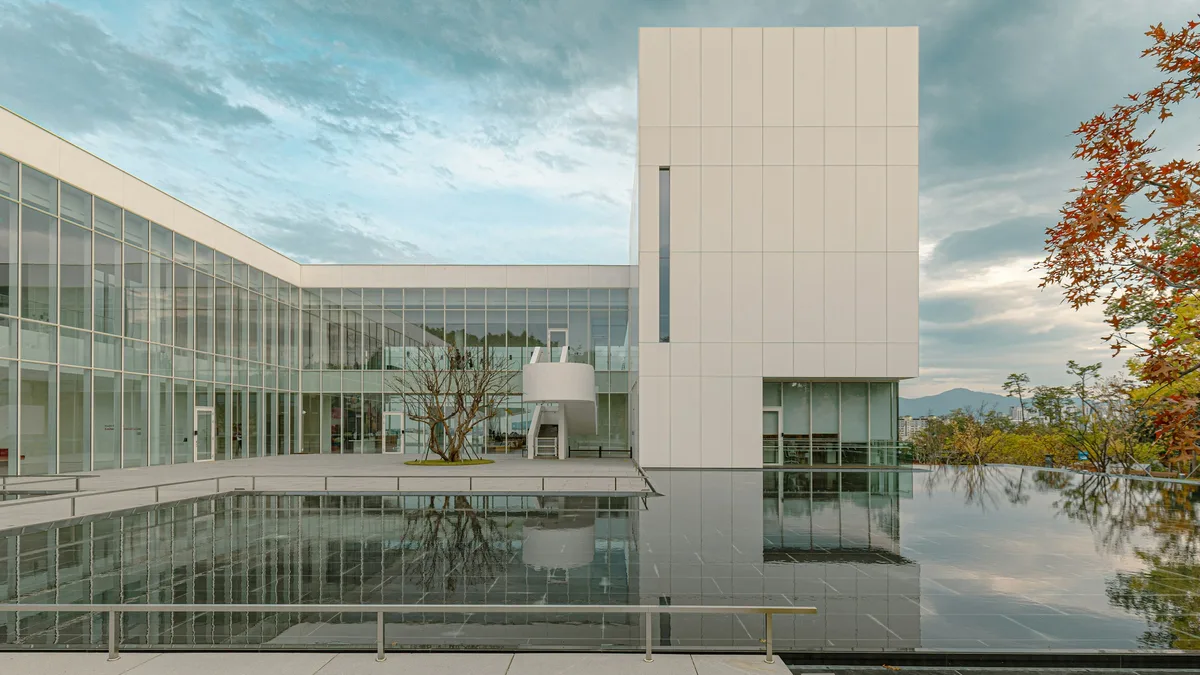 A modern museum building with a reflecting pool