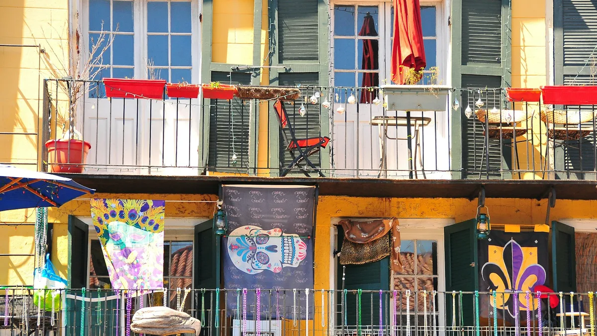 A colorful historic street in the French Quarter lined with balconies