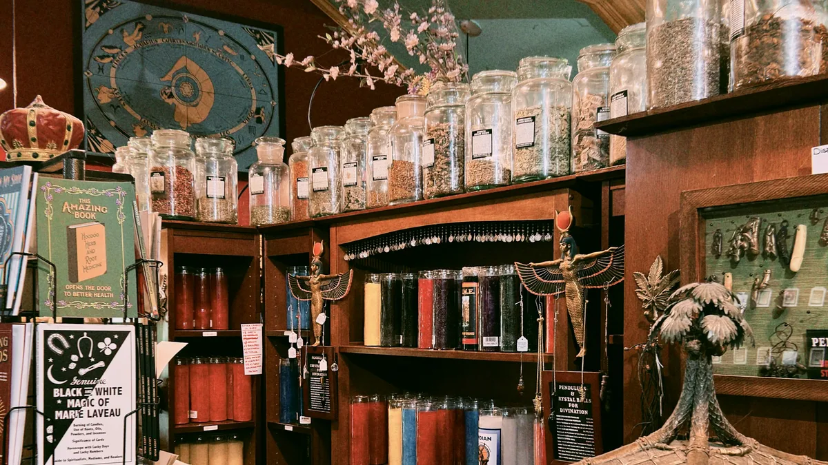 A collection of candles and mystical objects in a dimly lit shop
