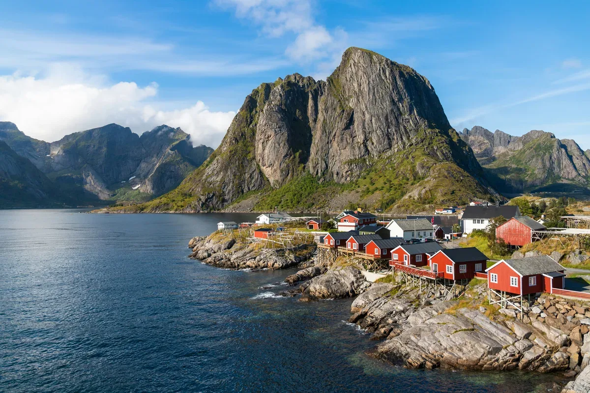 The fishing village of Hamnøy in the Lofoten Islands, Norway, under snow-capped peaks